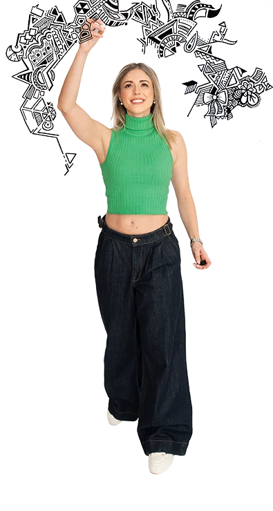 Dipl.-Ing. Julia Gorton zeichnet schwungvoll schwarze Kritzeleien in die Luft, trägt ein bauchfreies grünes Oberteil und dunkle Jeans – kreativ, energiegeladen und voller Ausdruck.